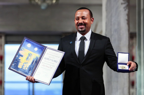 Ethiopia's Prime Minister Abiy Ahmed poses for the media after receiving the Nobel Peace Prize during the award ceremony in Oslo City Hall, Norway, last year.