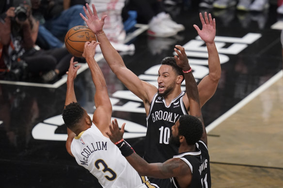 Simmons and fellow Melbourne-born guard Kyrie Irving try to shut down Pelicans sharpshooter CJ McCollum.