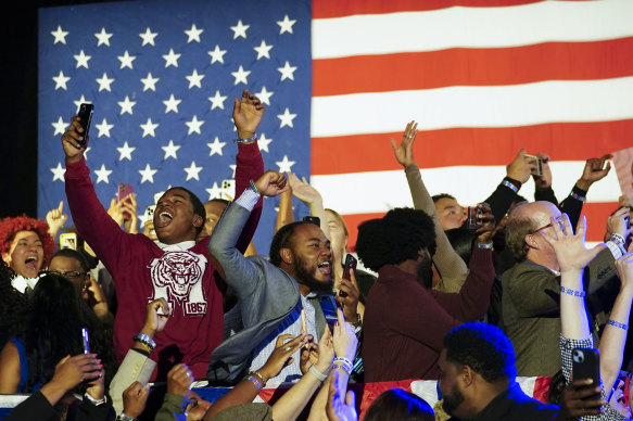 Supporters cheer during an election night watch party for Raphael Warnock on Wednesday (AEST).