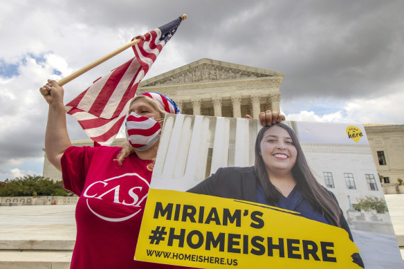 Ivania Castillo from Virginia holds a banner to show her support for dreamer Miriam from California, outside the US Supreme Court after the decision.
