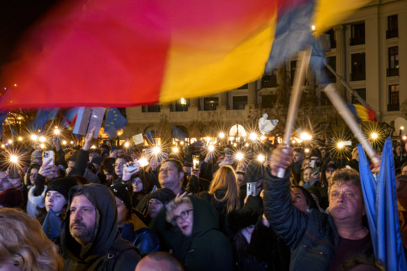 People hold mobile phones with flashlights during a pro-European rally in Bucharest, Romania, on Thursday.