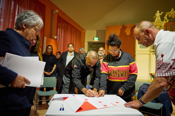 Australian Indigenous community leaders sign the paperwork taking custody of six ancestors from the Grassi Museum of Ethnology in Leipzig, November 17, 2022.