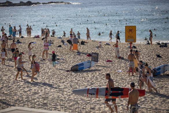 Crowds flocked to Coogee Beach on Saturday morning, prior to the beach being closed at 9am. 