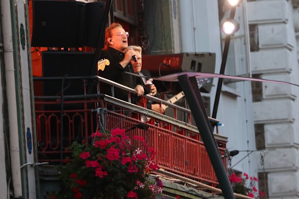 Bono looks out on the crowd as U2 perform an impromptu concert from a balcony in central Dublin, Ireland.