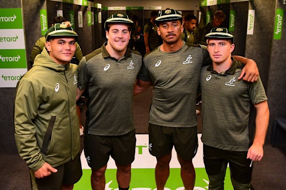 (From left) Noah Lolesio, Fraser McReight, Irae Simone and Tate McDermott crack half-smiles after receiving their first Test caps in a big defeat in 2020.