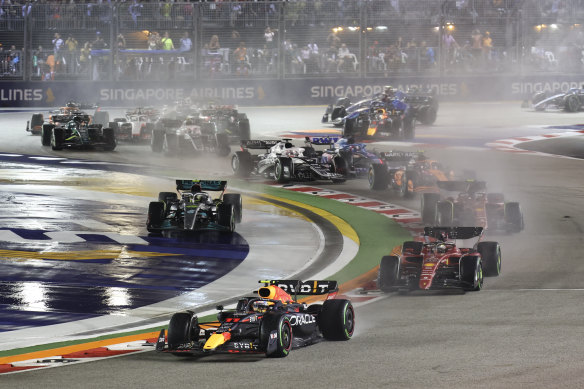 Red Bull driver Sergio Perez leads the field on the first lap in Singapore.