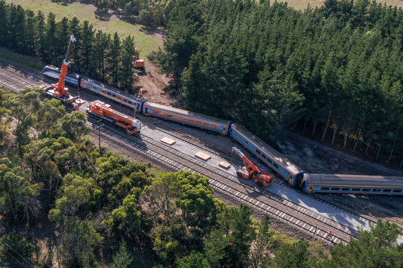 Cranes lifting part of the derailed train at Wallan on Sunday.