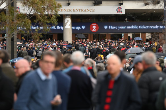 Fans queue to enter the MCG during the AFL first qualifying final between Collingwood and Melbourne on Thursday.
