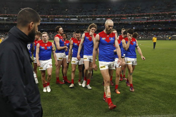 A dejected Melbourne leave the MCG after their third loss in a row.