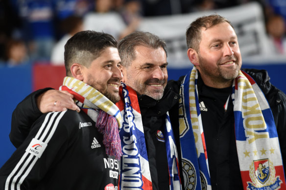 Arthur Papas, left, celebrates Yokohama F. Marinos’ title win in 2019 with Ange Postecoglou and Peter Cklamovski.