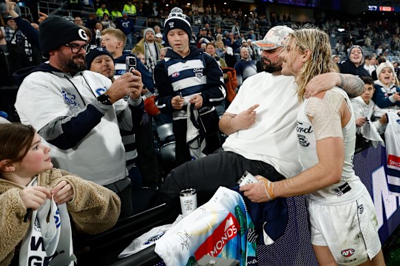 Bailey Smith of the Cats celebrates with fans.