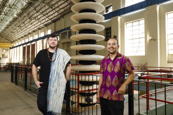 Artistic Directors of the upcoming 24th Biennale of Sydney Cosmin Costinaș and Inti Guerrero with an artwork by Eric-Paul Riege, installed at the old White Bay Power Station. 