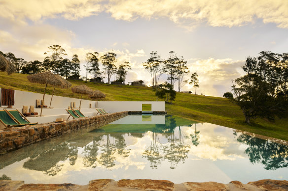 Poolside at Sun Ranch with the off-grid barns up on the ridge beyond.