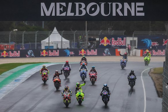 Riders farewell the crowd after the race was cancelled due to bad weather. 