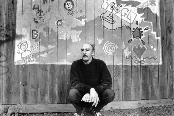Artist Mike Brown in the 1980s with some of the graffiti which he painted around North Fitzroy’s streets.