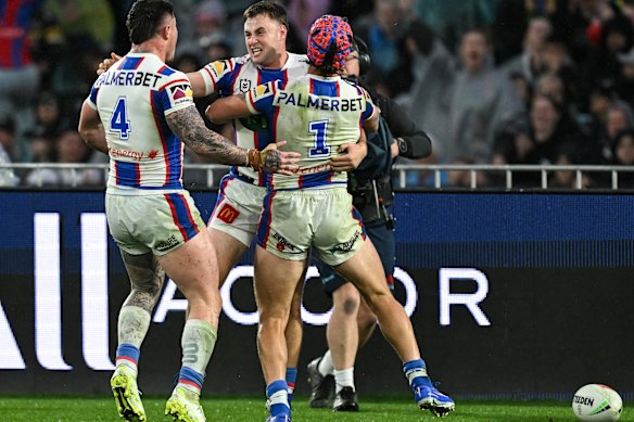 Sandon Smith celebrates his match-winning try with Kalyn Ponga and Bradman Best.
