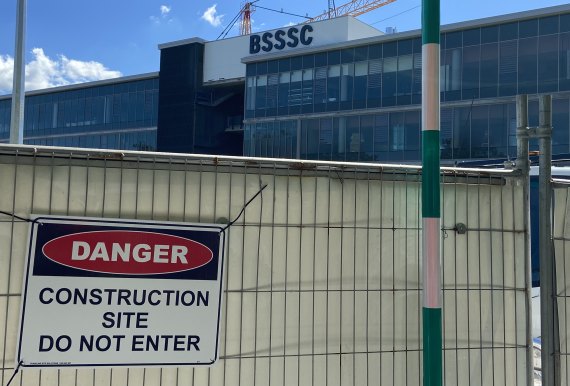 Signs warn of danger at the school construction site.