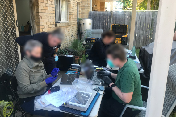 Australian Federal Police examining seized equipment.