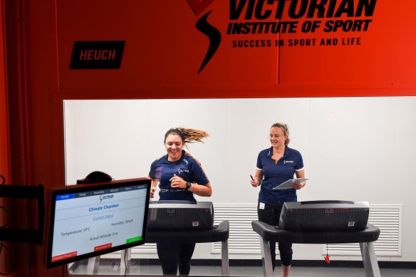 Sports scientist Sylvie Withers with sailor Casey Imeneo using the heat acclimatising chamber at the Victorian Institute of Sport.