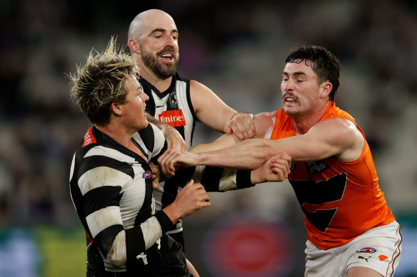 Magpie Jack Ginnivan and Lachie Ash of the Giants clash.