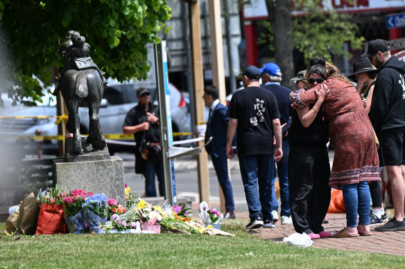 People leave floral tributes at the crash scene.