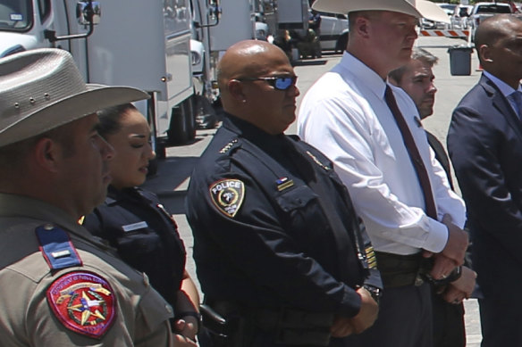 Uvalde School Police Chief Pete Arredondo, third from left, stands during a news conference outside of the Robb Elementary school in Uvalde, Texas.