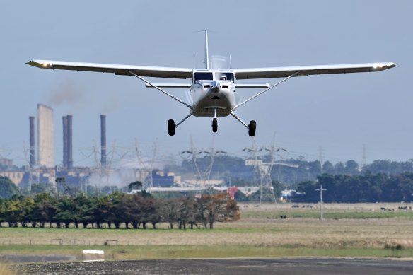 A Gippsaero GA8 Airvan taking off with the (since-demolished) Hazelwood power plant in the background.