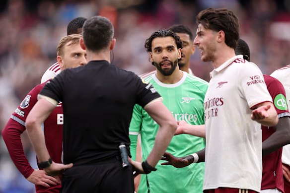 Players from both sides remonstrate with the referee.