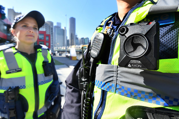 A police officer wears a body-worn camera.