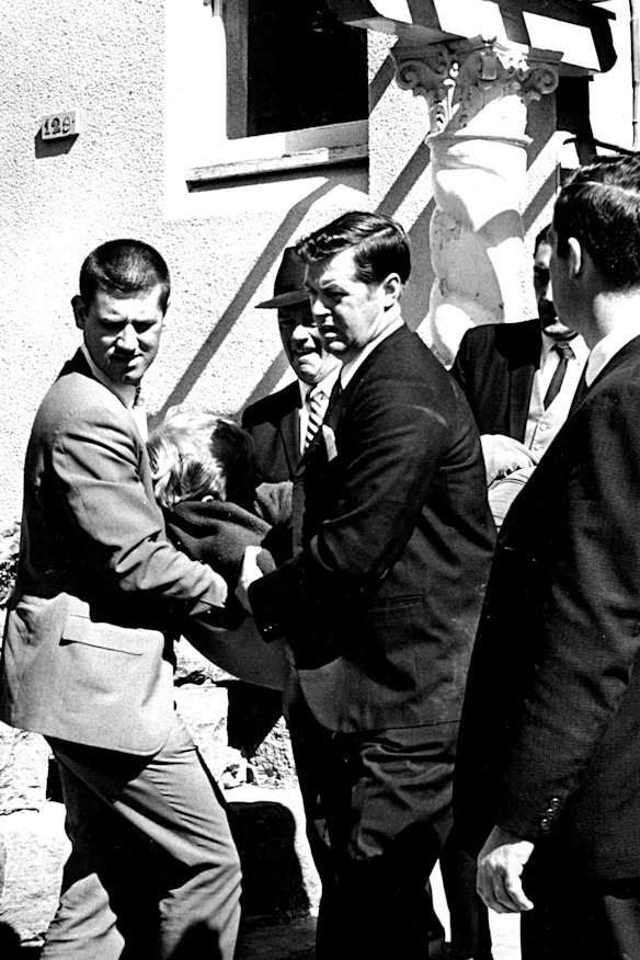 A man being carried by police from the scene of the siege on September 9, 1969.