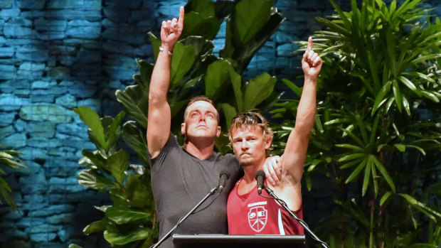 Ruben McDornan (left), who was the sole survivor of the sunken Dianne, points to the sky with second skipper Adam Kelly at the memorial service.