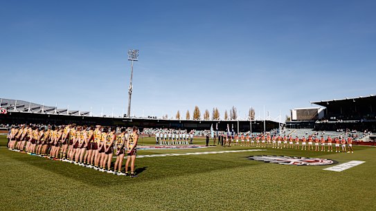 Hawthorn and Adelaide players line up during a ceremony ahead of Anzac Day before their clash at UTAS Stadium on Sunday.