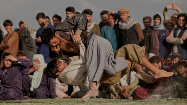 Afghans wrestlers fight during a match at the Chaman-e-Hozari Park in Kabul, Afghanistan.