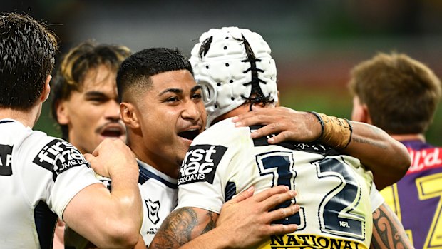 Josiah Karapani (centre) celebrates a try with Broncos teammates during their comeback round-three win against the Storm last week.