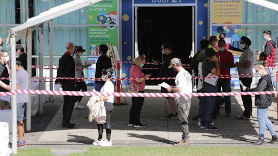 Lines at the Queensland government’s COVID vaccination hub at the Logan Entertainment Centre on Thursday.