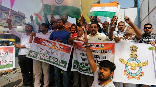 Indians celebrate in Ahmadabad as they react to reports of Indian aircrafts bombing Pakistan territory.
