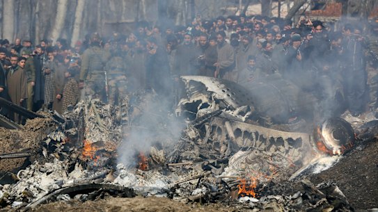 Kashmiri villagers gather near the wreckage of an Indian aircraft after it crashed in Budgam area on Wednesday.