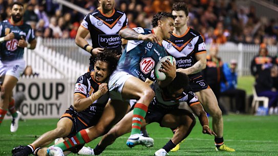 Latrell Mitchell is tackled by several Tigers in Tamworth.