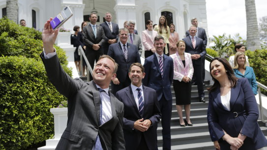 Deputy Premier Steven Miles wrangles his newly sworn-in cabinet colleagues for a selfie at Government House after the 2020 election.