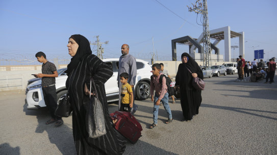 Palestinains wait at The border crossing bwteen Gaza Strip and Egypt in Rafah, Wednesday, Nov. 1, 2023. (AP Photo/Hatem Ali)
