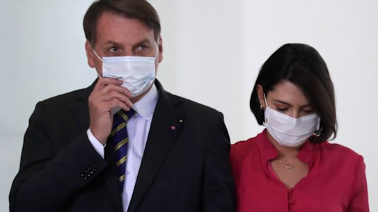 Brazil's President Jair Bolsonaro and his wife Michelle at an event in Brasilia on Wednesday, a day before she tested positive for COVID-19.