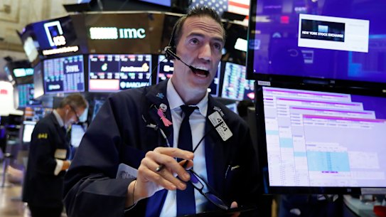 Trader Gregory Rowe works on the floor of the New York Stock Exchange.