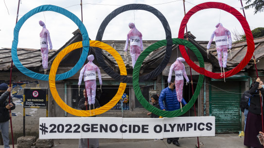Exile Tibetans use the Olympic Rings as a prop as they hold a street protest against the holding of 2022 Winter Olympics in Beijing