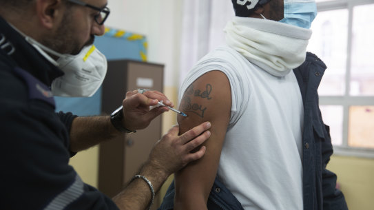 A medic with the Magen David Adom emergency service administers a dose of the Pfizer-BioNTech COVID-19 vaccine during a one-day clinic at a school near the Al Aqsa Mosque compound to vaccinate worshippers following Friday prayers in the Old City of Jerusalem. 