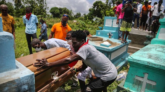 Francois Elmay is laid to rest in his family tomb in Les Cayes.