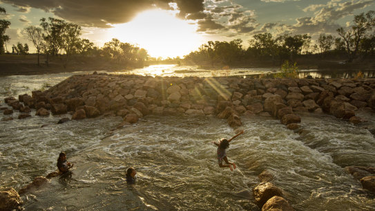 Kids swimming in the fishway at Brewarrina Weir, North West NSW, in February when the first strong flows in years came down the dry Barwon River in the Murray Darling Basin. 
