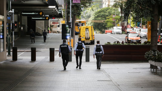 Police patrol empty streets during Brisbane’s lockdown, the strictest of the pandemic so far.