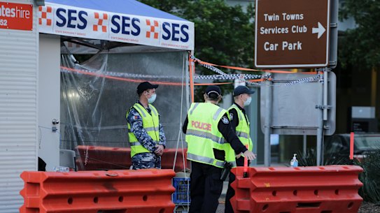 Defence and police personnel on Griffith Street, Coolangatta, on the Queensland side of the border.