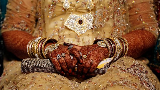 An Indian Muslim bride sits during a mass marriage where thirty-five couple got married in Mumbai, India, in 2014. 
