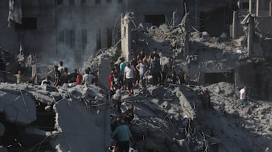Palestinians look for survivors following an Israeli airstrike on the  Bureij refugee camp in the Gaza Strip.